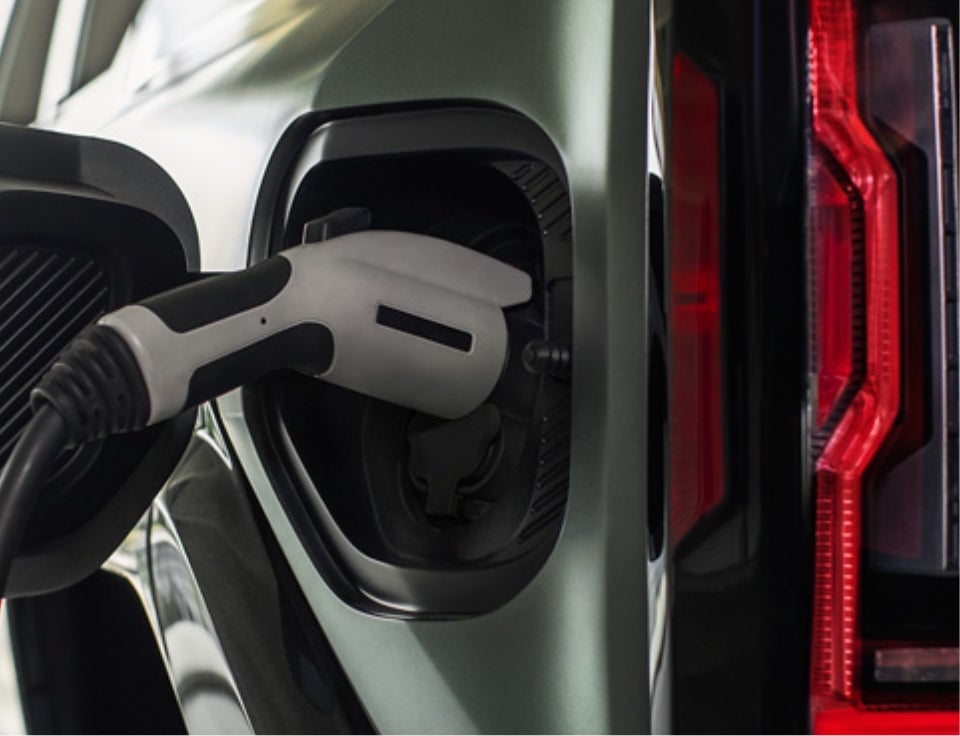 Close up of charging port with charger plugged in on a GMC Hummer EV SUV - Keweenaw GMC in Houghton MI