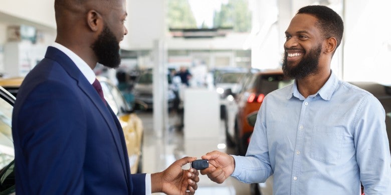 Man handing over car keys in Houghton, MI